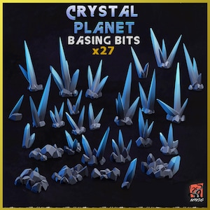 May include: A set of 27 blue crystal basing bits for miniature gaming. The crystals are various shapes and sizes, with some having a jagged edge and others having a smooth surface.