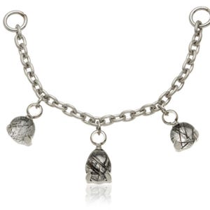 May include: A silver chain necklace featuring three gemstone pendants. The pendants are clear with black markings, and the chain has a simple, elegant design. Each end of the chain has a ring for attachment.