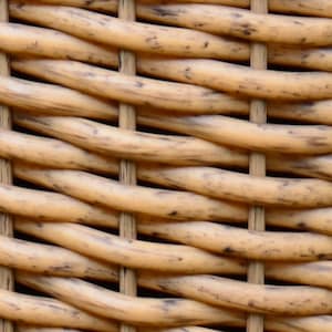 May include: Close-up of a woven wicker pattern. The natural-toned wicker is tightly woven in a repeating pattern, with vertical and horizontal supports. The wicker has variations in color, with darker brown spots.