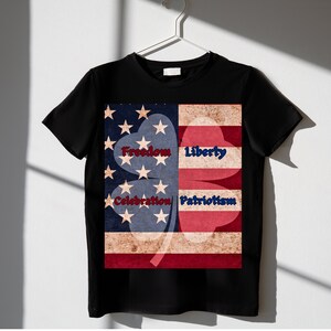 May include: Black t-shirt with a four-leaf clover design made up of an American flag. The clover leaves are labeled "Freedom", "Liberty", "Celebration", and "Patriotism".
