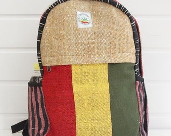 May include: A multi-coloured hemp backpack with a brown hemp flap and a green leaf logo. The backpack has black straps and a zipper closure.