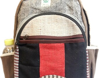 May include: A multi-coloured backpack with various textures and patterns. The backpack features a black zip, a red vertical stripe, and a side pocket holding a water bottle. The top of the backpack has a label that reads "Pure Hemp".