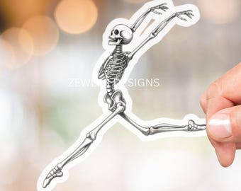 May include: A white sticker featuring a detailed illustration of a skeleton in a dynamic, leaping pose. The skeleton is depicted in shades of gray, with its bones clearly visible. The sticker has the text "ZEWLER DESIGNS".