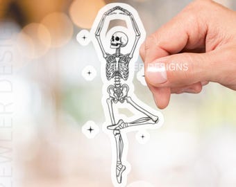 May include: A white sticker featuring a skeleton in a ballet pose. The skeleton is in a graceful arabesque, with arms raised. The sticker has the text "ZEWLER DESIGNS".