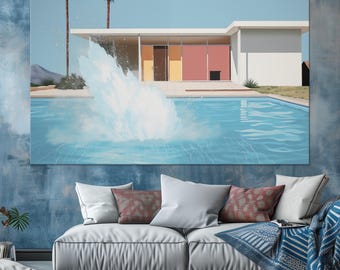 May include: A rectangular wall art print featuring a mid-century modern house with a flat roof, two palm trees, and a large water splash in a turquoise swimming pool. The scene is set against a clear blue sky with a desert landscape in the background.
