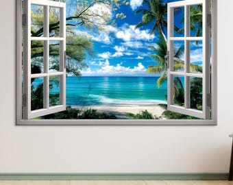 May include: A framed wall art piece depicting an open window with a tropical beach scene. The window frame is white, and the view shows a blue ocean, white sand beach, palm trees, and a bright blue sky with fluffy white clouds.