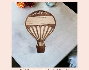 May include: Wooden hot air balloon shaped baby announcement plaque with the text "Perfect Landing on" and spaces for the date, time, weight, and length.