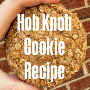 May include: A close-up of a large, round Hob Knob cookie with visible oats and a golden-brown color. The text "Hob Knob Cookie Recipe" is displayed in white block letters across the cookie.
