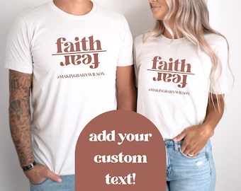 May include: Two white t-shirts with the text "faith over fear" in brown lettering. The text is separated by a line. The text "#makingbabywilson" is below the line. The shirts are worn by two people. The text "add your custom text!" is in a brown circle.