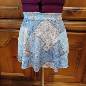 May include: A blue and brown patterned skirt with a flared hem. The skirt is made of a lightweight fabric and has a comfortable fit.