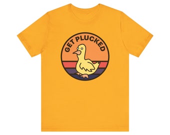 May include: A yellow t-shirt featuring a retro-style graphic of a duck with the text "GET PLUCKED" in a circle.