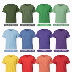 May include: A color chart displaying twelve short-sleeved t-shirts in various solid and heathered shades including military green, Irish green, light blue, purple, daisy yellow, and red. The text reads T-SHIRT COLORS I use Gildan and American Apparel.