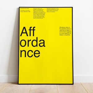 May include: A yellow poster with black text that reads "Aff ordance". The text is a definition of the term "affordance" in design. The poster is framed in black.