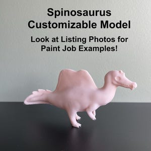Puede incluir: Un modelo de Spinosaurus rosa claro. El texto de la imagen dice: Spinosaurus Customizable Model. Look at Listing Photos for Paint Job Examples!