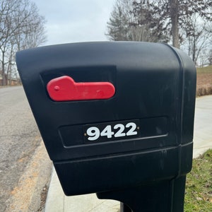 May include: Black mailbox with a red lever and a white number sticker that says "9422".