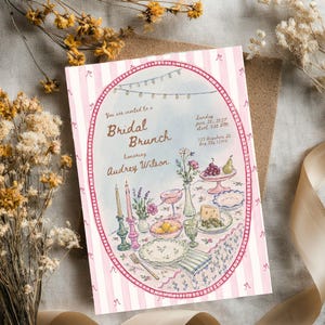 May include: A rectangular invitation card with a pink and white striped border featuring a central oval illustration of a table setting for a bridal brunch. The text reads: You are invited to a Bridal Brunch honoring Audrey Wilson, Sunday June 20, 2021, start 3:00 PM, 123 Anywhere St., Any City 12345.