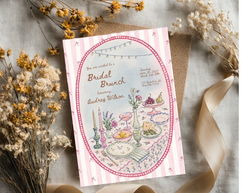 May include: A rectangular invitation card with a pink and white striped border featuring a central oval illustration of a table setting for a bridal brunch. The text reads: You are invited to a Bridal Brunch honoring Audrey Wilson, Sunday June 20, 2021, start 3:00 PM, 123 Anywhere St., Any City 12345.