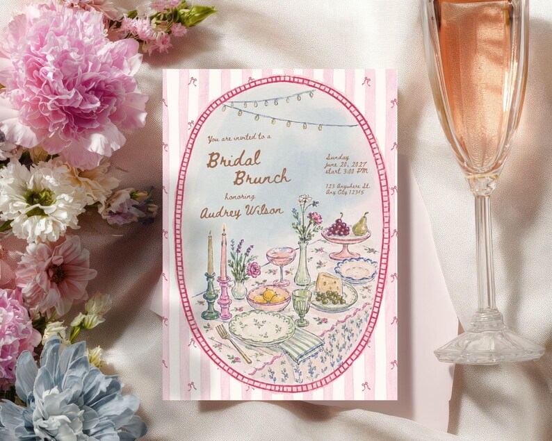 May include: A rectangular invitation card with a pink and white striped border featuring an oval illustration of a table set for a bridal brunch. The text reads: You are invited to a Bridal Brunch honoring Audrey Wilson, Sunday June 20, 2027.
