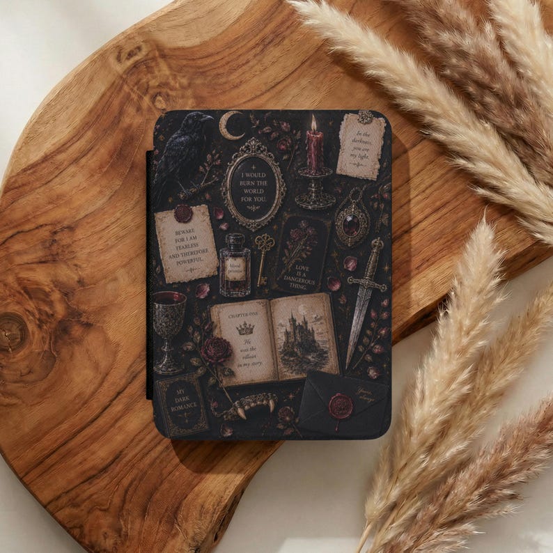 May include: A black e-reader case featuring a dark, gothic-inspired collage of illustrations including a raven, a burning candle, a dagger, an open book with a castle illustration, a wax-sealed envelope, a goblet, and various handwritten notes.