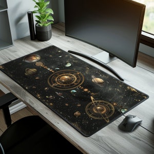May include: A black and gold mousepad with a celestial design featuring planets, stars, and a clock face. The mousepad is on a wooden desk with a computer monitor and a potted plant.
