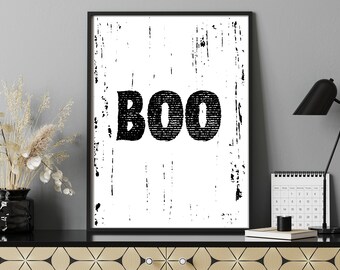 May include: Black and white printable wall art with the word "BOO" in a distressed font. The background is a white distressed texture.