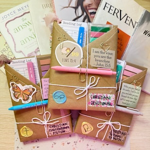 May include: A collection of brown paper-wrapped gifts, books, and reading logs. The gifts are adorned with stickers, gold paper clips, and white twine. Text on the gifts includes "Christian Devotional" and "Christian Contemporary Fiction."
