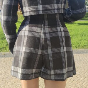 May include: Black and white plaid shorts with a high waist and a relaxed fit.
