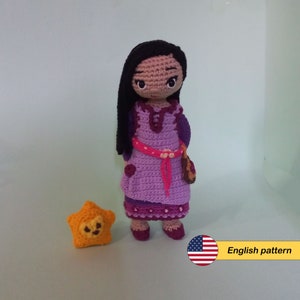 May include: Crochet pattern for a purple dress doll with long black hair and a yellow star. The pattern is in English.