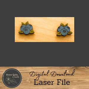 May include: Two wooden blueberry earrings with blue and green paint. The earrings are on a wooden background. Digital Download Laser File.