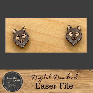 May include: A digital download laser file for a pair of wolf head earrings. The earrings are made of wood and have a dark brown color.
