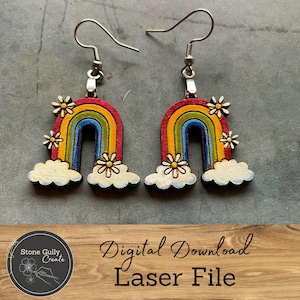 May include: A pair of rainbow-colored wooden earrings with white clouds and daisy accents. The earrings are laser cut and ready to be assembled. Digital Download Laser File.
