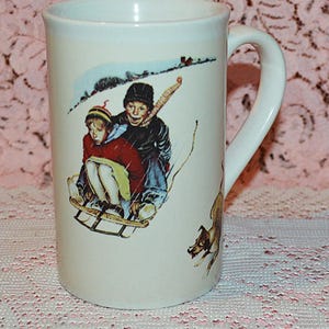 Young Love Sledding Norman Rockwell 12 oz Coffee Mug - Vintage Features A Boy and Girl Sledding with Their Dog - Microwave Dishwasher Safe