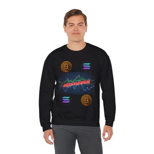 May include: Black crew neck sweatshirt with a graphic design featuring Bitcoin and Solana logos, a stock chart, and the text "KEEP PUMPING" in red and green. The sweatshirt is made of a soft, comfortable material.