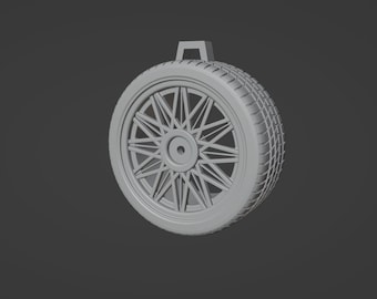 May include: A gray plastic model of a car tire with a detailed spoke wheel design.