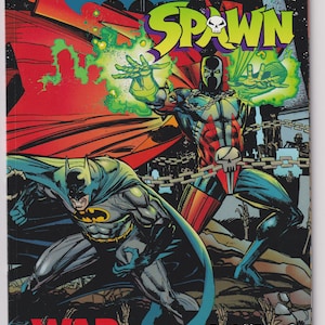 May include: Comic book cover featuring Batman and Spawn in action poses. The title "Batman Spawn" is prominently displayed in yellow and blue, with "War Devil" in red. The artwork showcases dynamic figures and vibrant colors.