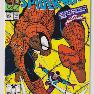 May include: A comic book cover featuring Spider-Man in a red and blue suit, swinging through the air with a yellow background. The cover text reads "Venom Lives!" and "The Amazing Spider-Man".
