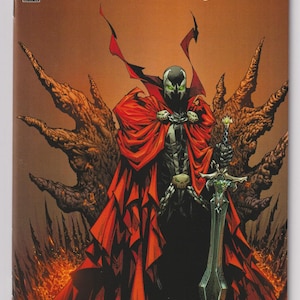 May include: Comic book cover for "King Spawn" #1. The artwork features a central figure in a black suit and a flowing red cape, holding a large sword. The background is a fiery, hellish landscape with the title text at the top.