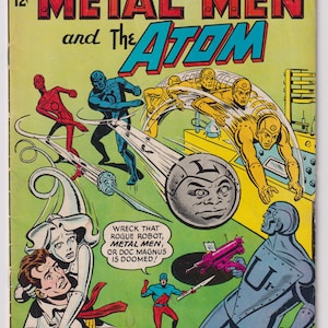 May include: Comic book cover for "Metal Men and The Atom" featuring action scenes with colorful characters. The cover has the text "Metal Men and The Atom" in large letters, with the DC Comics logo and issue number.