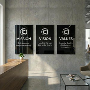 May include: Three rectangular black wall signs with white text and logos. The first sign reads MISSION To Inspire and innovate every day. The second sign reads VISION Leading the way to a better future. The third sign reads VALUES Integrity, Quality, Collaboration, Innovation.