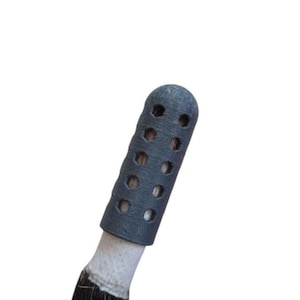 May include: A gray, cylindrical, 3D printed brush handle with a textured surface and a series of small holes. The handle is designed to fit over a brush.