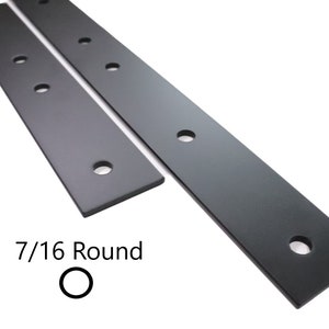 May include: Two black metal plates with multiple round holes. The plates are 7/16 round.