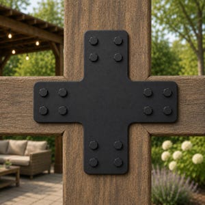May include: A matte black metal cross-shaped connector plate secured with twelve hexagonal bolts, joining two intersecting brown wooden beams. The heavy-duty bracket features rounded corners and a flat surface, providing structural reinforcement for the timber frame.