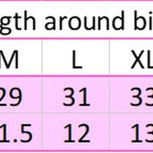 May include: A chart showing the length around the bicep in inches and centimeters for different sizes: XS, S, M, L, XL, 2XL, 3XL, and 4XL.