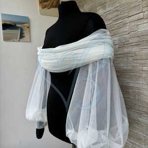 May include: White tulle off-the-shoulder sleeves with puffed long sleeves. The sleeves are made of a soft, sheer fabric and are perfect for adding a touch of elegance to any outfit.