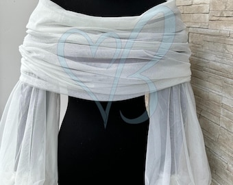May include: White tulle off-the-shoulder shrug with long, puffed sleeves. The shrug is made of a soft, sheer fabric and has a relaxed fit.