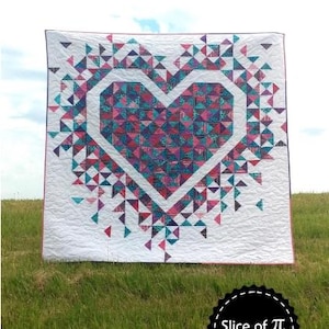 May include: A white quilt with a large heart design made of colorful triangles. The heart is outlined in white and filled with teal, pink, and purple triangles. The quilt is displayed on a grassy hill with the text "Exploding Heart".