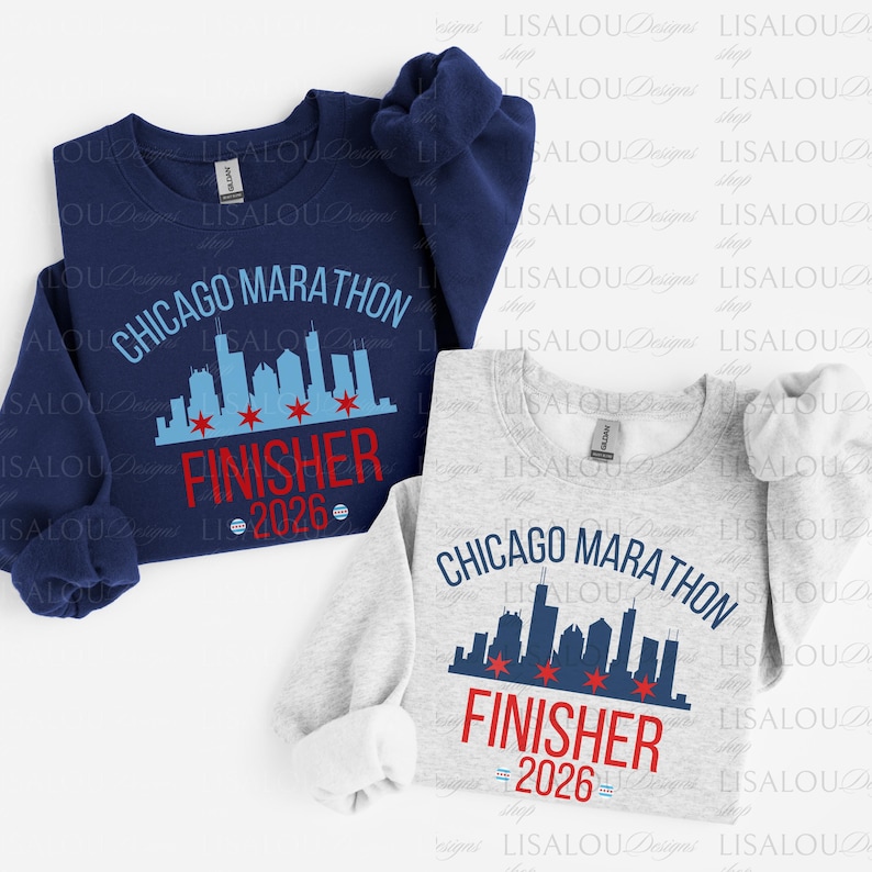 May include: A navy blue sweatshirt and a light gray sweatshirt, both featuring a Chicago skyline graphic, the text CHICAGO MARATHON, the word FINISHER in red, and the year 2026 with red star icons integrated into the city silhouette design.