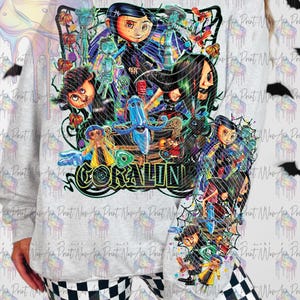 May include: A light gray sweatshirt featuring a colorful graphic from the movie "Coraline." The design includes characters, the movie title, and a spiderweb design. The sweatshirt has a crew neck and long sleeves.