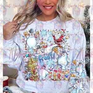 May include: A white sweatshirt with a colorful Christmas design featuring Frosty the Snowman, Santa Claus, and other characters. The design includes the words "Frosty" and a string of Christmas lights.