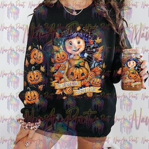 May include: A black sweatshirt with a colorful graphic print of a girl with a black cat and pumpkins. The text "The fall had never seemed so fall" is printed on the sweatshirt.